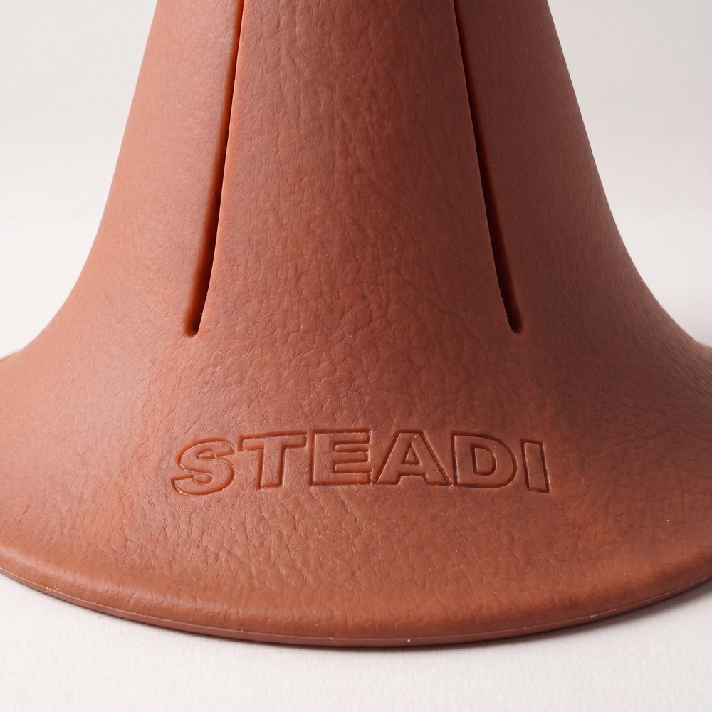 A close macro of the outer edge of the flared base where it meets the surface it is standing on.